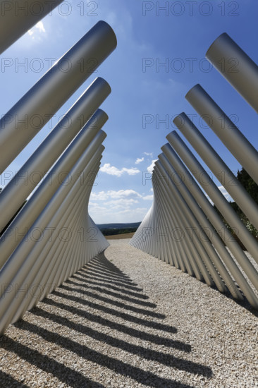Art in public space, sculpture made of aluminum profile pipes by artist Martin Burchard, life's horizon path near Mundingen, light and shadow, gravel, clouds, blue sky, walk-in art, paths of reflection and refreshment on the Ehinger Alb, Baden-Württemberg, Germany