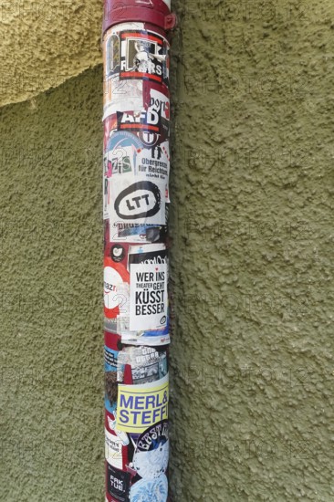 Downpipe covered with stickers, advertising, event information, façade, local storks, Tübingen, Baden-Württemberg, Germany