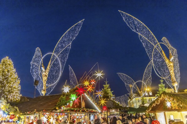 Baroque Christmas market with illuminated angels between the Protestant City Church and the Catholic Church of the Most Holy Trinity. Sights on the market square in the evening. Ludwigsburg, Baden-Württemberg, Germany