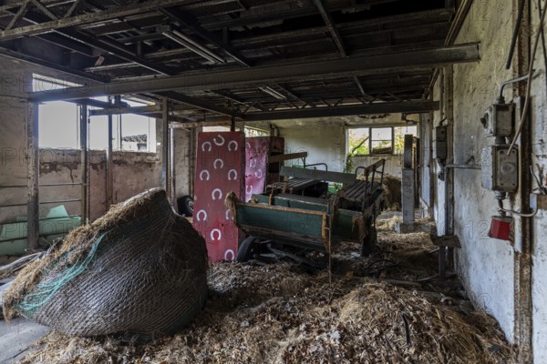 Old building with straw and equipment, dilapidated plant of a former agricultural production cooperative of the former GDR, LPG, Lost Place, Müggenburg, Fischland-Darß-Zingst, Western Pomerania Lagoon Area National Park, Mecklenburg-Western Pomerania, Germany
