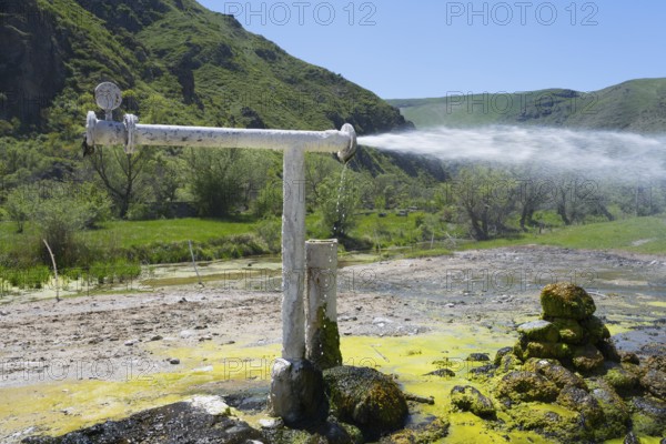Natural water source with sparkling water jet against green mountain landscape, Vardzia, Vardzia, Samtskhe—Javakheti region, Samtske Javacheti, Lesser Caucasus, Georgia