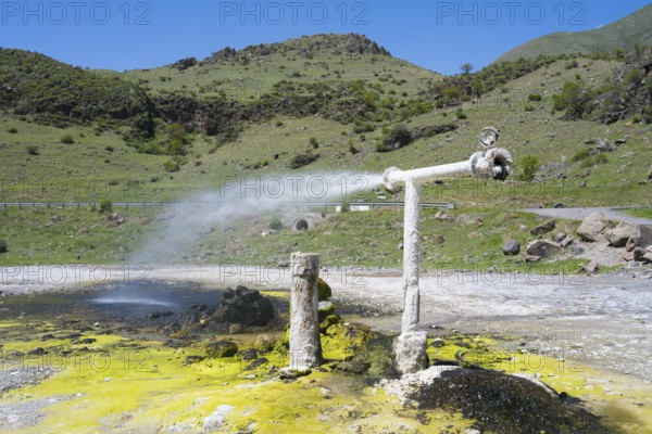 Mineral water spring with vertical pipeline in hilly landscape under blue sky, Vardzia, Samtskhe—Javakheti region, Samtske Javacheti, Lesser Caucasus, Georgia