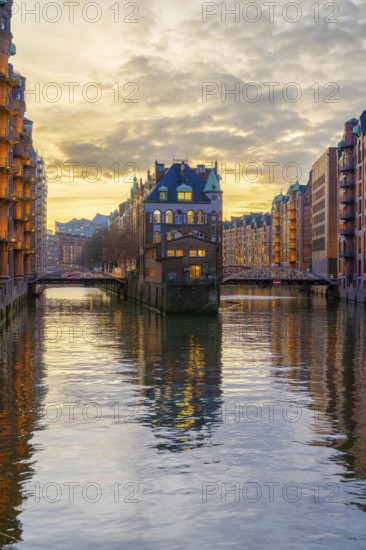 Water castle in the Speicherstadt Hamburg on a wall frame fleet with clouds in the background at golden hour, Hamburg, Germany