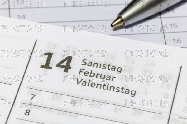Calendar page on February 14, Valentine's Day, presented with ballpoint pen, diary