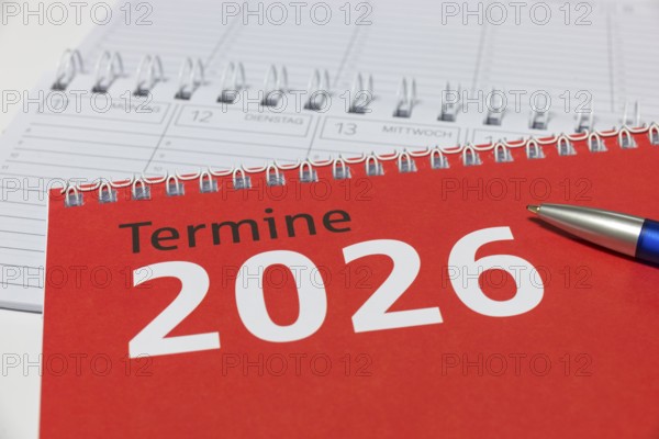 Red calendar for 2026 with blue pen on spiral binding