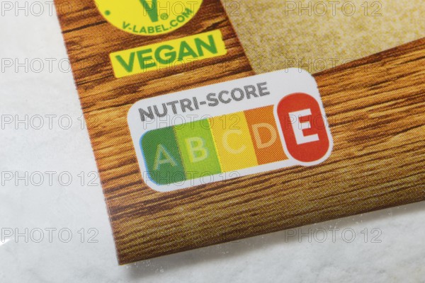 Close-up of Nutri-Score label with vegan seal on wooden packaging