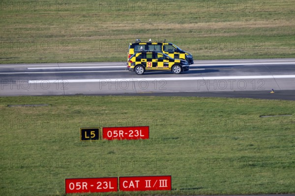 Inspection of runway 05R/23L 3000m main runway south, by Marshall vehicles also called Follow Me vehicle, pilot vehicle, apron supervision, directs aircraft to their parking position, at Düsseldorf Airport, DUS North Rhine-Westphalia, Germany