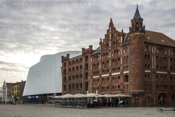 Front right, tower warehouse built in 1905 and warehouse II built in 1888, brick building, in front of patio, restaurant, behind Ozeaneum, right behind Silo III, harbour island, old town, UNESCO World Heritage Site, Hanseatic City of Stralsund, Mecklenburg-Western Pomerania, Germany
