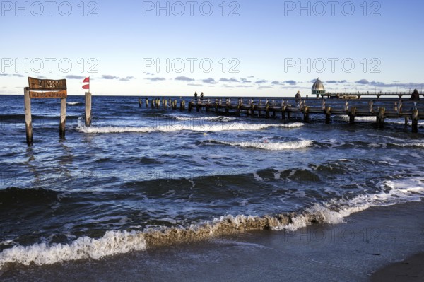 Wooden sign in the sea with inscription Zingst and wooden footbridge, back pier with diving gondola, panorama, evening light, Zingst, Fischland-Darß-Zingst, Western Pomerania Lagoon Area National Park, Mecklenburg-Western Pomerania, Germany