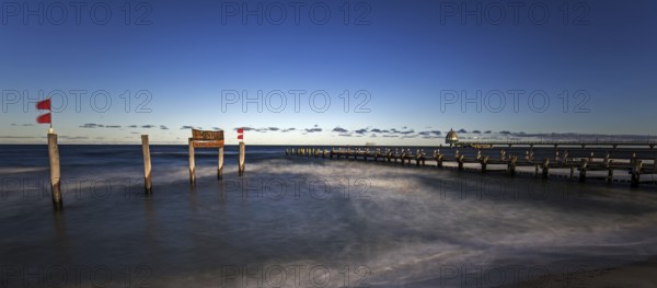 Wooden sign in the sea with inscription Zingst and Holzsteg, panorama, long exposure, evening light, Zingst, Fischland-Darß-Zingst, Western Pomerania Lagoon Area National Park, Mecklenburg-Western Pomerania, Germany