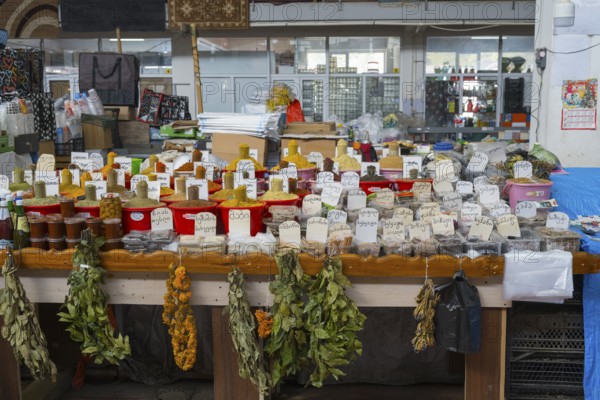 An extensive market stand with spices in red buckets and dried herbs, Akhaltsikhe market, Samtskhe-Javakheti region, Samtskhe-Javakheti, Georgia