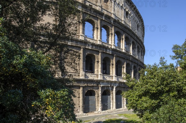 View of the partially restored façade outer façade of the Roman Colosseum from ancient times, west side, Rome, Lazio, Italy