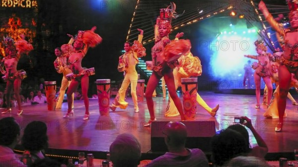Revue dancers in opulent colorful costume and with feather headdress at Club Tropicana, Havana, Havana, Cuba