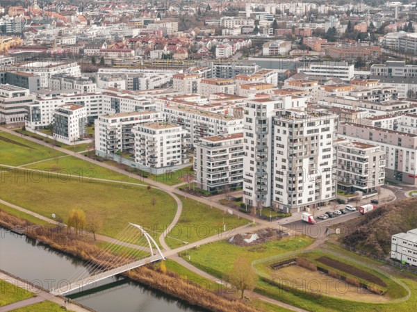 Residential complexes next to a river with a bridge in an urban area, Böblingen airfield, Germany