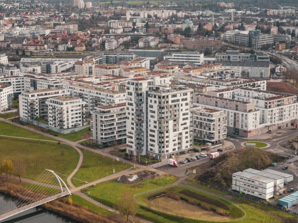 Large residential buildings and bridge across a river in an urban landscape, Böblingen airfield, Germany