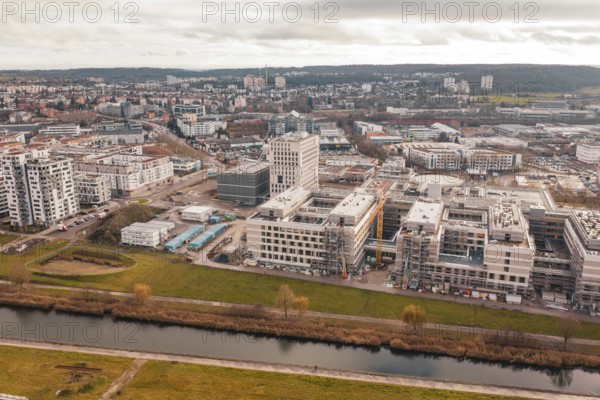 New urban development with staggered modern buildings next to a river in the foreground, Böblingen, Germany