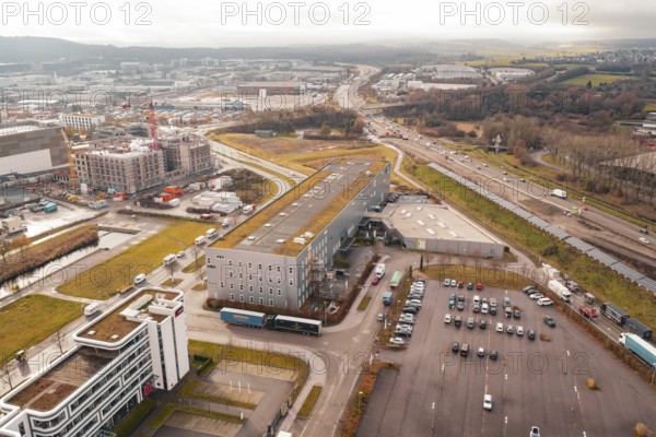 Industrial area and large roads with adjacent green fields under a cloudy sky, Böblingen, Germany