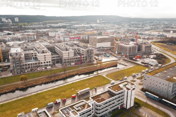 City view with modern buildings under construction along a small river in an urban area, Böblingen, Germany