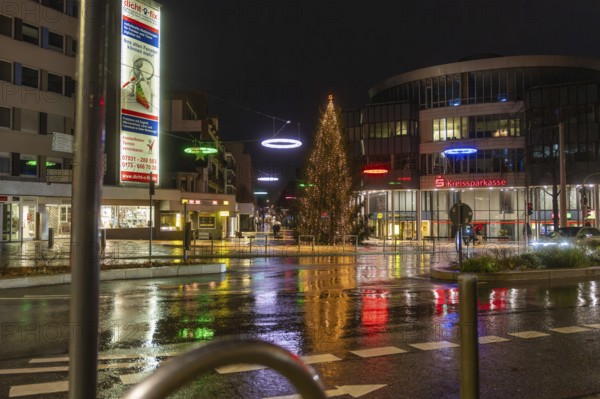 Illuminated Christmas tree and colorful street lights in the city at night, Böblingen Christmas market, Germany