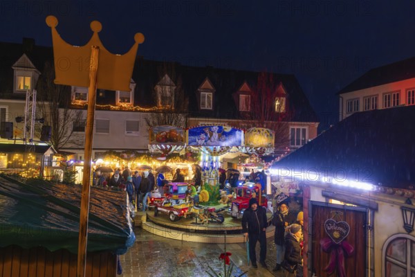 Overview of a Christmas market with crown, carousel and festive lighting at night, Böblingen Christmas market, Germany