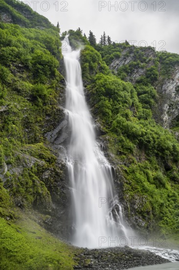 Horsetail Falls waterfall on the Lowe River in a green gorge, long exposure, Keystone Canyon, Richardson Highway, Alaska, USA