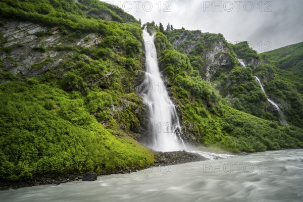 Horsetail Falls waterfall on the Lowe River in a green gorge, long exposure, Keystone Canyon, Richardson Highway, Alaska, USA