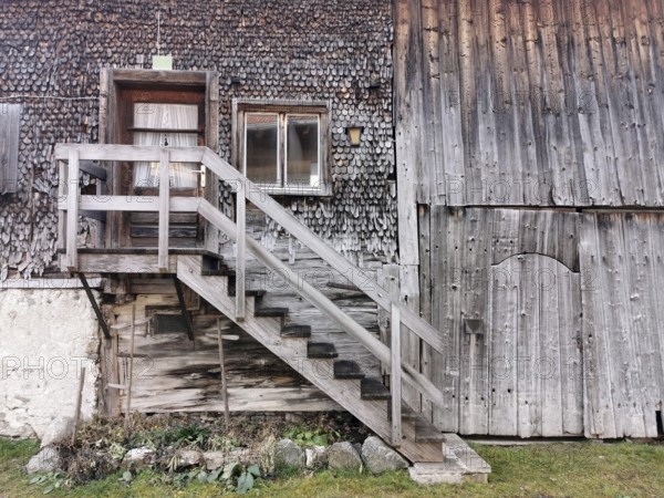 Detail of an old farmhouse in Schöllang, wooden staircase and entrance door, Illertal, Oberallgäu, Allgäu, Bavaria, Germany