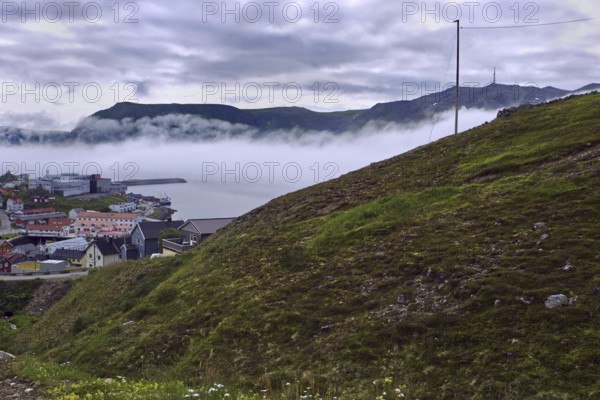 View of Honningsvag city and mountains through thick fog, Honningsvag