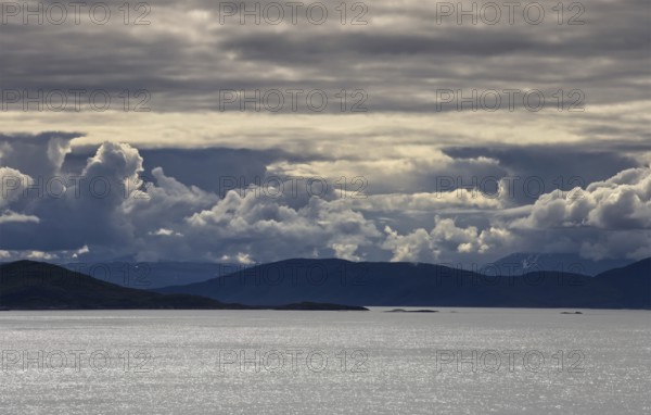 Wide expanse of water under a blanket of thick clouds, Norway