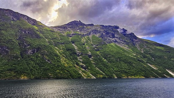 Mountain landscape with clouds and a quiet fjord, Norway