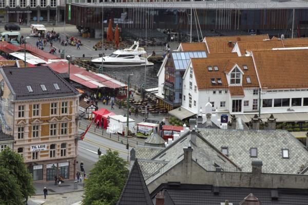 Urban scene with a marketplace, boats and surrounding buildings, Bergen Norway
