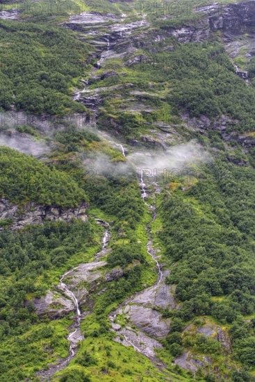 Landscape with green hills, waterfalls and fog, Norway