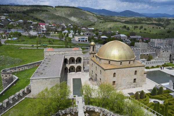 Golden dome mosque surrounded by green countryside and a small village, Rabati Fortress, Akhaltsikhe, Samtskhe-Javakheti region, Samtskhe-Javakheti, Georgia