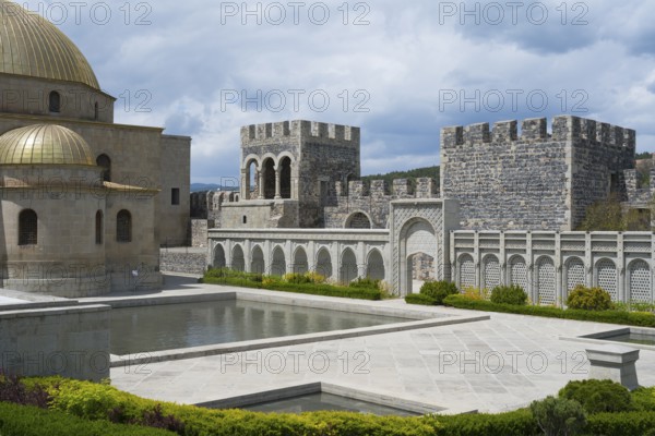 Stone building with golden dome, arcades and water basin in front of an imposing stone wall, Rabati Fortress, Akhaltsikhe, Samtskhe-Javakheti region, Samtskhe-Javakheti, Georgia