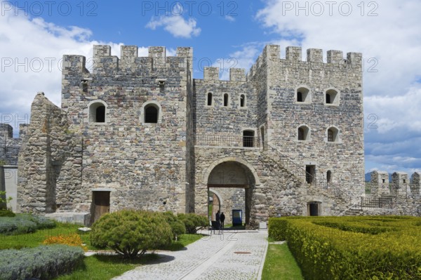 Massive stone fortress with towers and well-kept garden under slightly cloudy sky, Rabati fortress, Akhaltsikhe, Samtskhe-Javakheti region, Samtskhe-Javakheti, Georgia
