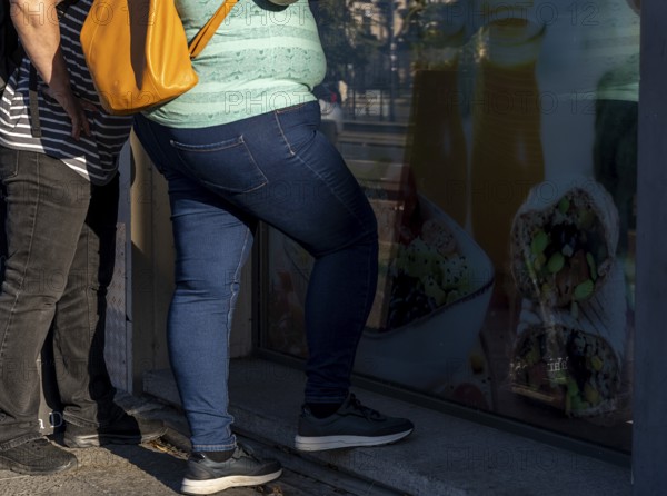 People with obesity stand at an ice cream parlour, Berlin, Germany