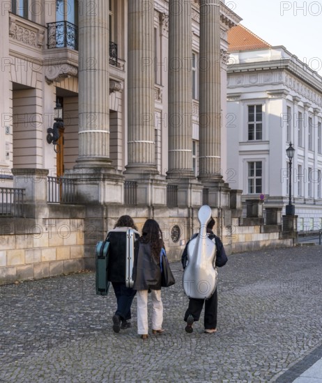 Young musicians with their instruments on their way to Unter den Linden music school, Berlin, Germany