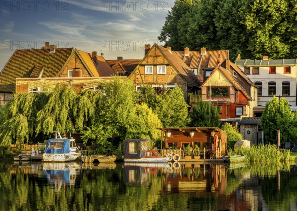 Evening sun, houses and boat docks on the lake in Mölln, Schleswig-Holstein, Germany