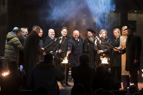 Karsten Dreinhöfer (Chairman of the Margot Friedländer Foundation), Kai Wegner (Governing Mayor of Berlin), Julia Klöckner (President of the German Bundestag) and Yehuda Teichtal (Rabbi of the Chabad-Lubavitch movement) light the fire together with other participants at the lighting of the 20th anniversary Hanukkah in front of the Brandenburg Gate, Berlin, 17 December 2025