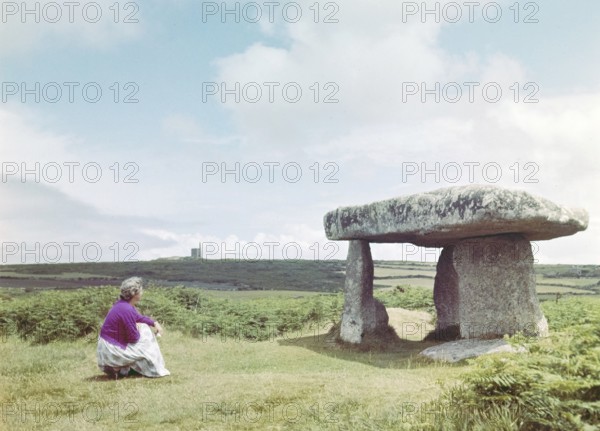 Woman visiting Lanyon Quoit, prehistoric Neolithic chambered tomb, Cornwall, England, UK, c 1960