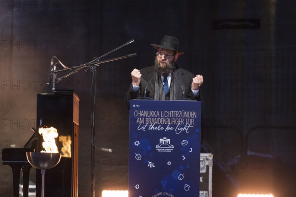 Yehuda Teichtal (Rabbi of the Chabad-Lubavitch movement) speaks at the lighting of lights to mark 20 years of Hanukkah in front of the Brandenburg Tor tor, Berlin, 17 December 2025