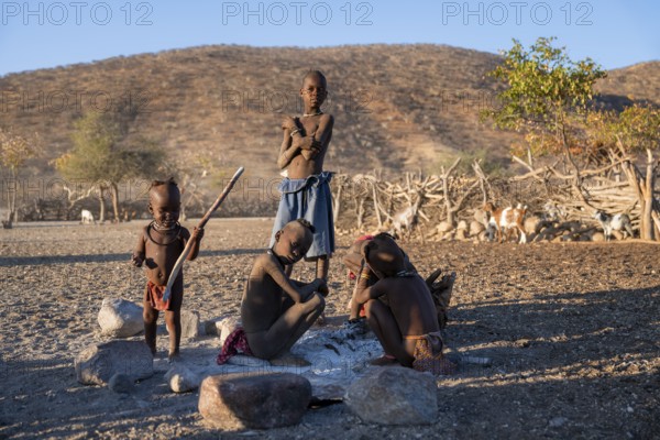Himba children at a fireplace, traditional Himba village, Kaokoveld, Kunene, Namibia