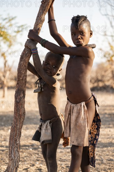 Two Himba children, traditional Himba village, Kaokoveld, Kunene, Namibia