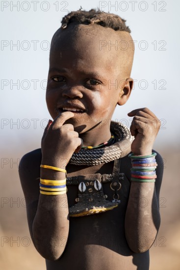 Portrait, young Himba child, traditional Himba village, Kaokoveld, Kunene, Namibia