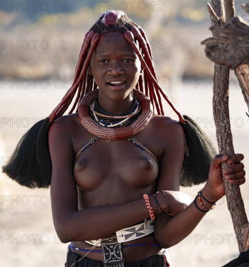Young Himba woman with jewelry, portrait, traditional Himba village, Kaokoveld, Kunene, Namibia