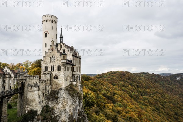 Castle and autumnal forest, Lichtenstein Castle, Honau, Echaz Valley, Swabian Jura, Baden-Württemberg, Germany