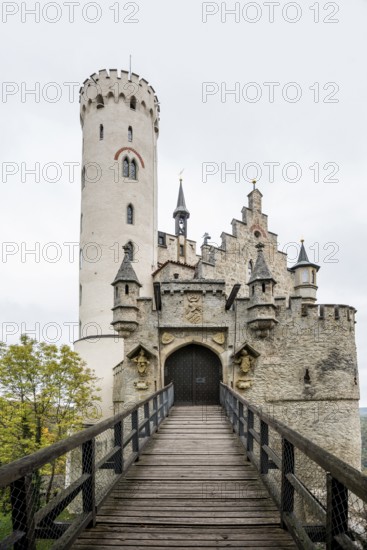 Castle and autumnal forest, Lichtenstein Castle, Honau, Echaz Valley, Swabian Jura, Baden-Württemberg, Germany