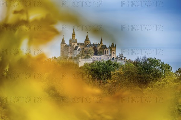 Castle and autumnal forest, Hohenzollern Castle, Hechingen, Swabian Jura, Baden-Württemberg, Germany