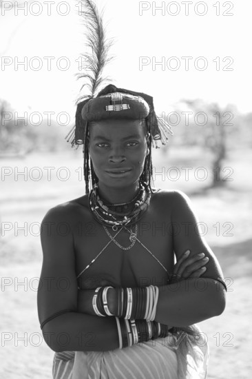 Black and white, portrait, brightly decorated woman of the Hakaona tribe, also Havakona or Hakawona, near Opuwo, Kunene, Namibia