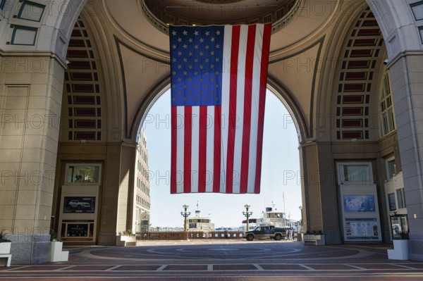 American flag fluttering, distinctive archway, Boston Harbor Hotel, Rowes Wharf, Freedom Trail, Financial District, Downtown, Boston, Massachusetts, New England, USA